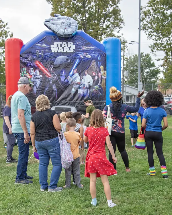 Children wait in line for Star Wars themed inflatable.