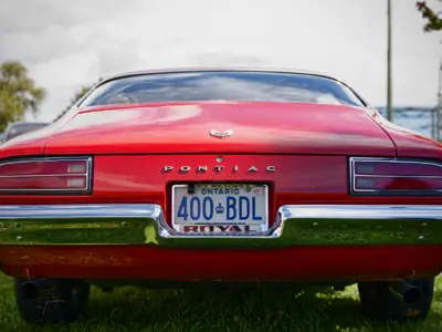 Photo of the back of a red vintage car during Applefest 2022