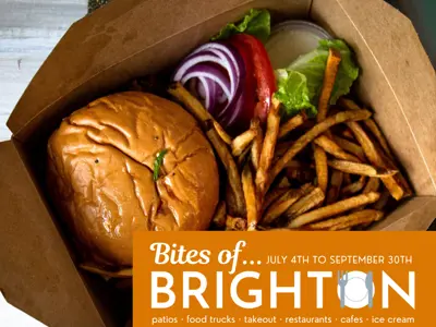 Takeout container with hamburger and fries with Bites of Brighton logo in the foreground