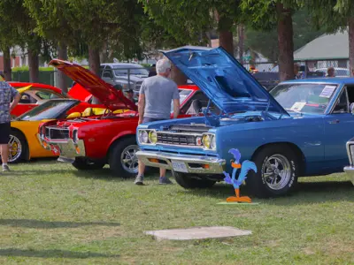 Blue pickup truck displayed at the Car Show with a road runner cutout.