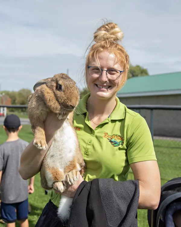 Woman holding a large rabbit.
