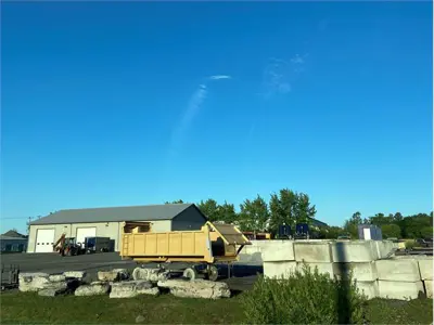 Photo of Warehouse with large rocks and trailers parked out the front